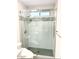 Walk-in shower boasting seamless glass enclosure, shower-head, bench, and tiled surround at 16414 S 36Th St, Phoenix, AZ 85048