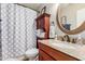 Cozy bathroom with granite counters, wood cabinets, and decorative mirror at 16441 N 138Th Ave, Surprise, AZ 85374