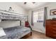 This bedroom has a bunk bed, a window and hardwood flooring at 16441 N 138Th Ave, Surprise, AZ 85374