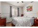 This is another bedroom with hardwood flooring, a window and a bed at 16441 N 138Th Ave, Surprise, AZ 85374