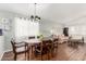 Bright dining area featuring a wooden table, chandelier, and view into the living space, perfect for Gathering dinners at 16441 N 138Th Ave, Surprise, AZ 85374