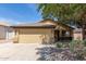 Single Gathering home featuring a two-car garage, desert landscaping, and a neutral color scheme, perfect for curb appeal at 16441 N 138Th Ave, Surprise, AZ 85374