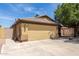 Single-story home featuring a spacious two-car garage, desert landscaping, and a light-colored exterior, perfect for easy access at 16441 N 138Th Ave, Surprise, AZ 85374
