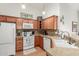 Charming kitchen with light wood cabinets, a white appliance package, and granite countertops at 16441 N 138Th Ave, Surprise, AZ 85374