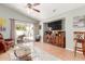 Open-concept living area featuring tile floors, a ceiling fan, and sliding glass doors, perfect for easy indoor-outdoor living at 16441 N 138Th Ave, Surprise, AZ 85374
