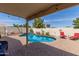 Inviting backyard pool with lush landscaping, lounge chairs, and a covered patio area at 16441 N 138Th Ave, Surprise, AZ 85374