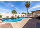 Outdoor living area featuring a refreshing pool, desert landscaping, and dining with a grill at 16441 N 138Th Ave, Surprise, AZ 85374