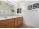 Bright bathroom features double sinks and a large mirror at 16526 W Desert Ln, Surprise, AZ 85388