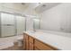 Well-lit bathroom with glass door shower and modern vanity at 16526 W Desert Ln, Surprise, AZ 85388