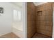 Modern bathroom with tiled shower, a separate tub and natural light at 16526 W Desert Ln, Surprise, AZ 85388