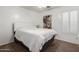 Cozy bedroom with plush carpet, white bedding and decor at 16526 W Desert Ln, Surprise, AZ 85388