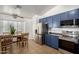 Bright eat-in kitchen with stainless steel appliances and blue cabinets at 16526 W Desert Ln, Surprise, AZ 85388