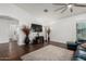 Spacious living room featuring plenty of natural light, a cozy rug, hardwood floors and lots of open space at 16526 W Desert Ln, Surprise, AZ 85388
