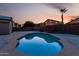 Inviting backyard swimming pool reflecting the sunset, set in a private, walled yard at 16526 W Desert Ln, Surprise, AZ 85388