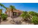 Charming backyard with covered patio, mature trees, and desert-friendly landscaping at 17585 N Coyote Lakes Pkwy, Surprise, AZ 85378