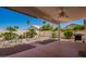 Inviting backyard featuring mature trees, a rock garden, and a built-in grill at 17585 N Coyote Lakes Pkwy, Surprise, AZ 85378