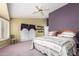 Charming bedroom with backyard access, floral quilt, and decorative shelving at 17585 N Coyote Lakes Pkwy, Surprise, AZ 85378