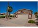 Inviting single-story home with a well-maintained front yard and a two-car garage at 17585 N Coyote Lakes Pkwy, Surprise, AZ 85378