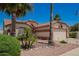 Beautiful exterior with mature palm trees, manicured landscaping, and a tiled roof at 17585 N Coyote Lakes Pkwy, Surprise, AZ 85378