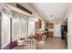 Bright kitchen nook with large windows, shutters, and an adjacent kitchen at 17585 N Coyote Lakes Pkwy, Surprise, AZ 85378