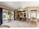 Bright living room featuring a ceiling fan, sliding glass doors, and a dining area at 17585 N Coyote Lakes Pkwy, Surprise, AZ 85378