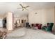 Open-concept living room showcasing high ceilings, tile flooring, and comfortable seating at 17585 N Coyote Lakes Pkwy, Surprise, AZ 85378