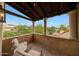 Covered balcony with brick flooring, outdoor furniture, and mountain views at 19054 N 97Th Pl, Scottsdale, AZ 85255