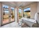 A bright bathroom features a soaking tub, natural light, and serene views, creating a spa-like retreat at 19054 N 97Th Pl, Scottsdale, AZ 85255