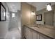 Elegant bathroom featuring double vanity, large mirror and subway tile shower at 19054 N 97Th Pl, Scottsdale, AZ 85255