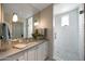 Modern bathroom with glass-enclosed shower, subway tile, and white cabinetry at 19054 N 97Th Pl, Scottsdale, AZ 85255