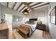 Relaxing bedroom featuring a woven bench, neutral color palette and wood beam ceiling at 19054 N 97Th Pl, Scottsdale, AZ 85255