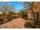 Charming courtyard featuring brick pavers, desert landscaping, and a tranquil outdoor seating area at 19054 N 97Th Pl, Scottsdale, AZ 85255