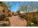 Charming courtyard featuring brick pavers, desert landscaping, and a tranquil outdoor seating area at 19054 N 97Th Pl, Scottsdale, AZ 85255