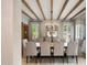 An elegant dining room features a long table, upholstered chairs, and natural light, creating a refined setting at 19054 N 97Th Pl, Scottsdale, AZ 85255