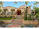 Charming stucco exterior with tile roof, mature trees and desert landscaping at 19054 N 97Th Pl, Scottsdale, AZ 85255