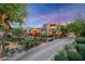 Expansive, mature landscaping and architectural lighting highlight this charming desert home at 19054 N 97Th Pl, Scottsdale, AZ 85255