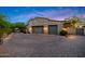 Attached two car garage featuring paneled doors, a paver driveway and well-manicured landscaping at 19054 N 97Th Pl, Scottsdale, AZ 85255