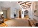 Hallway featuring hardwood floors, wooden beam ceiling and access to the laundry room and bathroom at 19054 N 97Th Pl, Scottsdale, AZ 85255