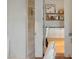 View into a bright kitchen with white cabinets, subway tile, and open shelving, from a doorway at 19054 N 97Th Pl, Scottsdale, AZ 85255