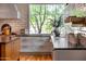 Bright kitchen features a large window, subway tile backsplash, and light cabinets with dark countertops at 19054 N 97Th Pl, Scottsdale, AZ 85255