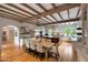 Open kitchen and dining area with wooden beams, stainless steel appliances, and large central island at 19054 N 97Th Pl, Scottsdale, AZ 85255