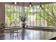 Bright kitchen features a large window overlooking lush greenery and a sleek black countertop at 19054 N 97Th Pl, Scottsdale, AZ 85255