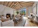 Bright living room features vaulted ceilings, fireplace, and large windows with views of the backyard pool at 19054 N 97Th Pl, Scottsdale, AZ 85255