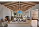 Elegant living room showcasing vaulted ceilings, a cozy fireplace, and a beautiful view of the backyard pool at 19054 N 97Th Pl, Scottsdale, AZ 85255
