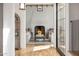 Inviting living room featuring a brick fireplace, white sofas, and hardwood floors at 19054 N 97Th Pl, Scottsdale, AZ 85255
