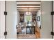Bright office space featuring custom built-ins, wood beams, modern lighting and a decorative rug at 19054 N 97Th Pl, Scottsdale, AZ 85255
