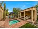 Inviting outdoor space with a spa, pool, fireplace, and covered patio area for relaxing and entertaining at 19054 N 97Th Pl, Scottsdale, AZ 85255