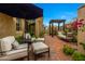 Charming outdoor seating area with comfortable chairs, lush landscaping, and a serene atmosphere for relaxation at 19054 N 97Th Pl, Scottsdale, AZ 85255