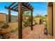 Private outdoor shower area with wood pergola, bench, desert landscaping and brick pavers at 19054 N 97Th Pl, Scottsdale, AZ 85255