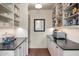 Walk-in pantry with ample storage space and black countertops at 19054 N 97Th Pl, Scottsdale, AZ 85255